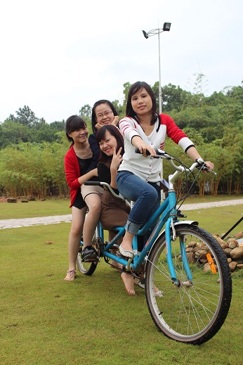 A group of people riding on the back of a bicycleDescription automatically generated